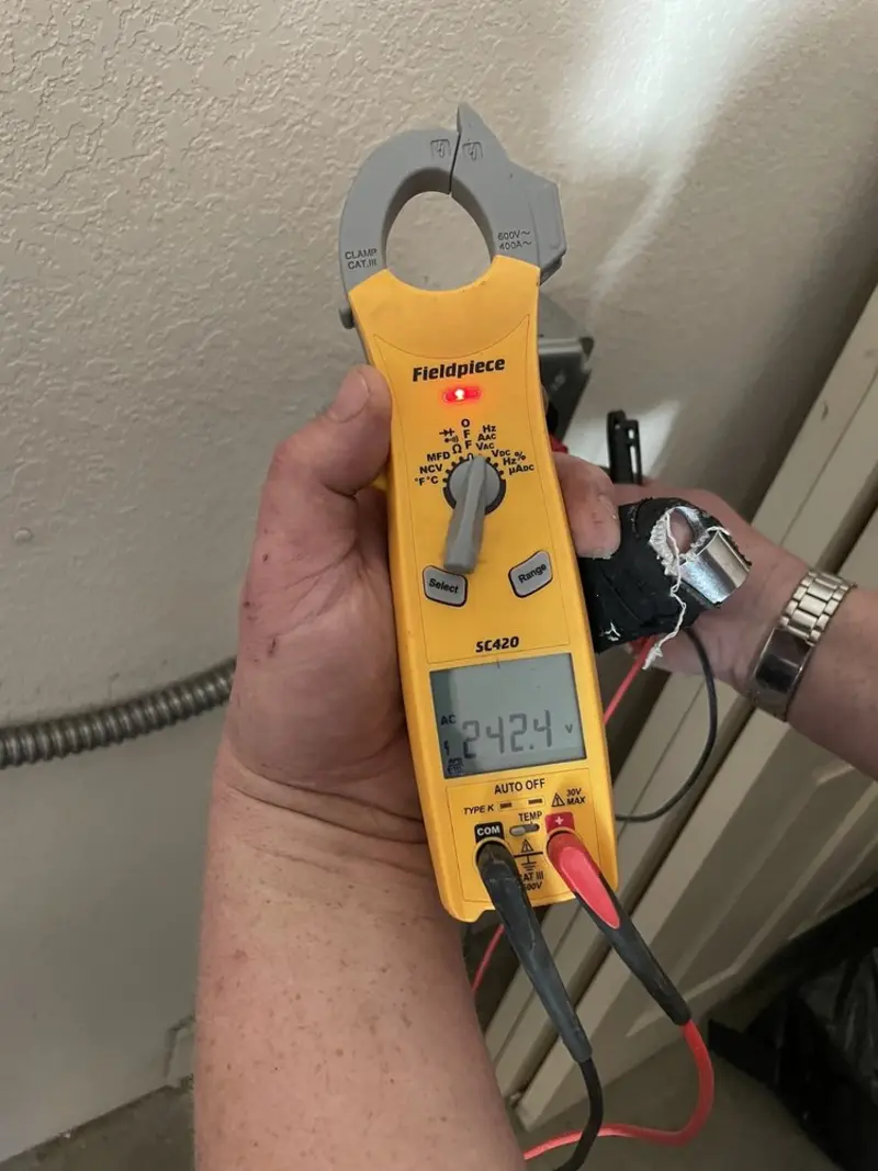 Voltage testing with clamp meter during Outlet Installation in Moriah